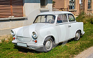 Trabant car parked in front of the house.