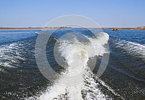 Trace from a boat on the water. Motor boat foamed the water with him