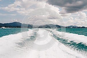 Trace tail of speed boat on water surface in the sea