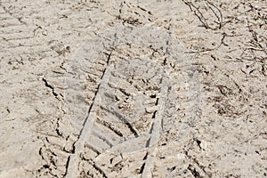 Traces of the car. Traces of technology on the sand