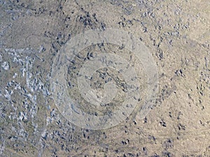 Traces of construction equipment on the soil, aerial view. Lifeless land, wasteland