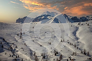 Traces of skiers and snowboarders on white snowy meadows of Fedare, Dolomites
