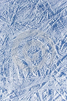 Traces of skiers on white snow in the mountains