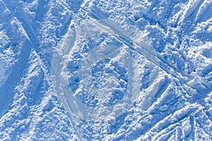 Traces of skiers on white snow in the mountains