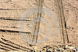 Traces of tire treads on the sand