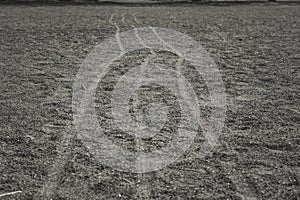 Traces of wheels on small pebbles. Background texture with traces of bicycle wheels