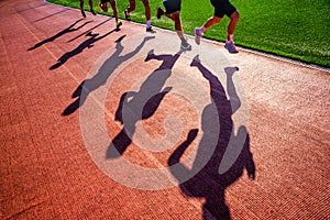 Track and Field sport athletics photo. Shadow of runners on the track