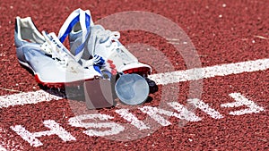 Track spikes with medals at the finish line
