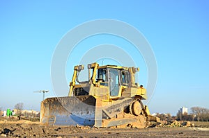 Track-type bulldozer, earth-moving equipment. Land clearing, grading, pool excavation, utility trenching, utility trenching photo