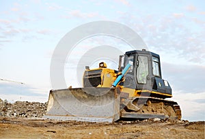 Track-type bulldozer, earth-moving equipment. Land clearing, grading, pool excavation, utility trenching, utility trenching and