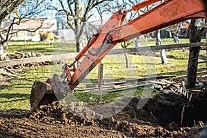 Track-type loader excavator machinery doing earthmoving and leveling at earth quarry