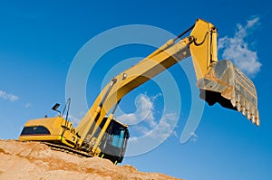 Track-type loader excavator at sand