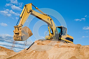 Track-type loader excavator at sand