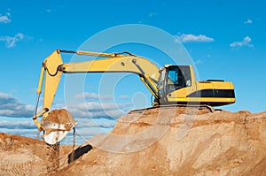 Track-type loader excavator at sand