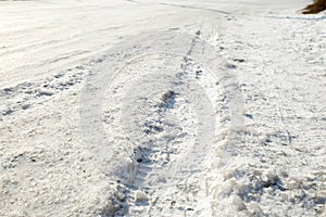 Track from a wheel on an icy track. Dangerous driving conditions. Icy road with tracks from the wheels of cars. The concept of