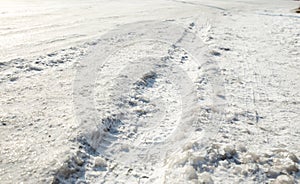 Track from a wheel on an icy track. Dangerous driving conditions. Icy road with tracks from the wheels of cars. The concept of