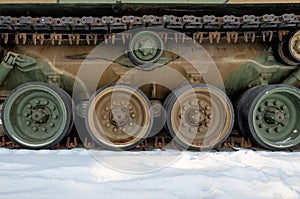 Track and wheels of the old tank in winter