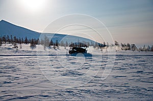 Tracked all-terrain vehicle in winter ladscape in Kamchatka