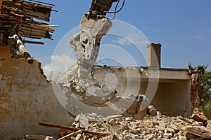 Tracked excavator demolishing old buildings