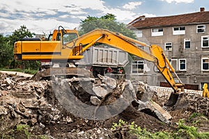 Tracked excavator loading the material in a truck