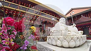 Tracking in Beautiful Chinese temple exterior with a white Happy Buddha Statue