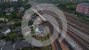 Tracking of Sbahn train driving on multitrack railway line. Aerial view on city train. Berlin, Germany