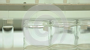 Tracking shot of glass beakers in a lab