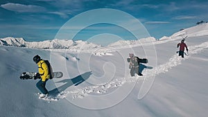 Tracking shot group of active sport backpacker wearing equipment going on white snow