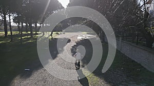 Tracking shot of little kid riding a bike on a dirt road