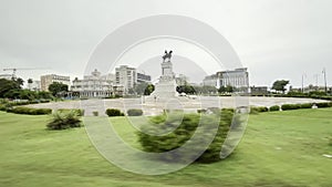 Tracking shot of Monument Maximo Gomez in Havana old city center in front of Malecon street