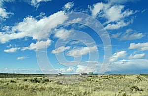 Tracks and cars on a long road to the sky horizon