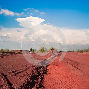 Tracks and heaps of red iron oxid land photo