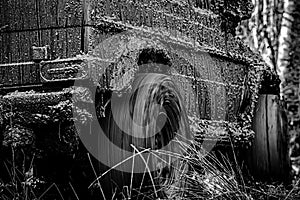 Tracks on a muddy field. Expedition offroader. Bottom view to big offroad car wheel on country road and mountains