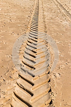 Tracks in the sand made by tractor