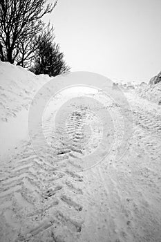 Tracks on snow covered road