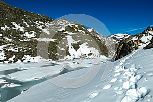 Tracks in snow next to glacier lakes leading to the Hoer Sonnblick in High Tauern Alps in Carinthia and Salzburg, Austria, Europe