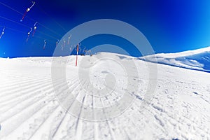 Tracks of snowcat on the packed snow at ski resort