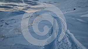 Tracks from a snowmobile in the mountains