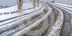 Tracks on a snowy road in Daybreak during winter