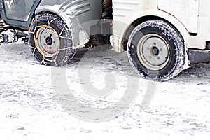 Traction chains on the wheels of a snowblower