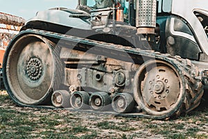 Tractor on an agricultural field close up. A modern new tracked tractor is very close