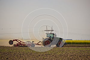 a tractor in an agricultural field shredding the earth
