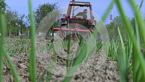 Tractor with agricultural machinery cultivates land