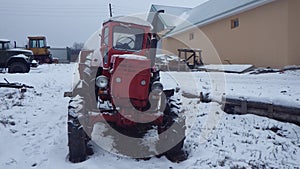 Tractor in agriculture and farming in winter