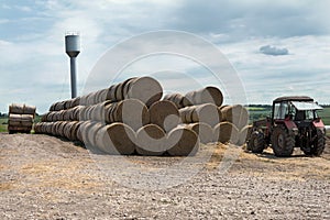 Tractor with bales of hay in the vicinity of the farm