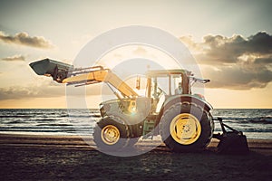 Tractor on the beach at sunrise