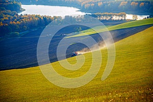 Tractor in a beautiful region with flower meadows and fields. Slovakia, Central Europe, Liptov.