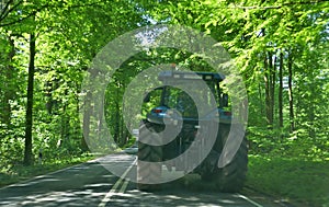 Tractor from behind, on a lonely country road in Germany