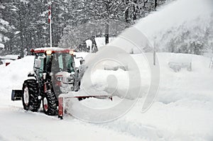 Tractor blowing snow