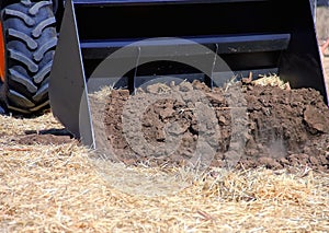 The tractor bucket heats the ground. Tractor bucket, front loader in actin